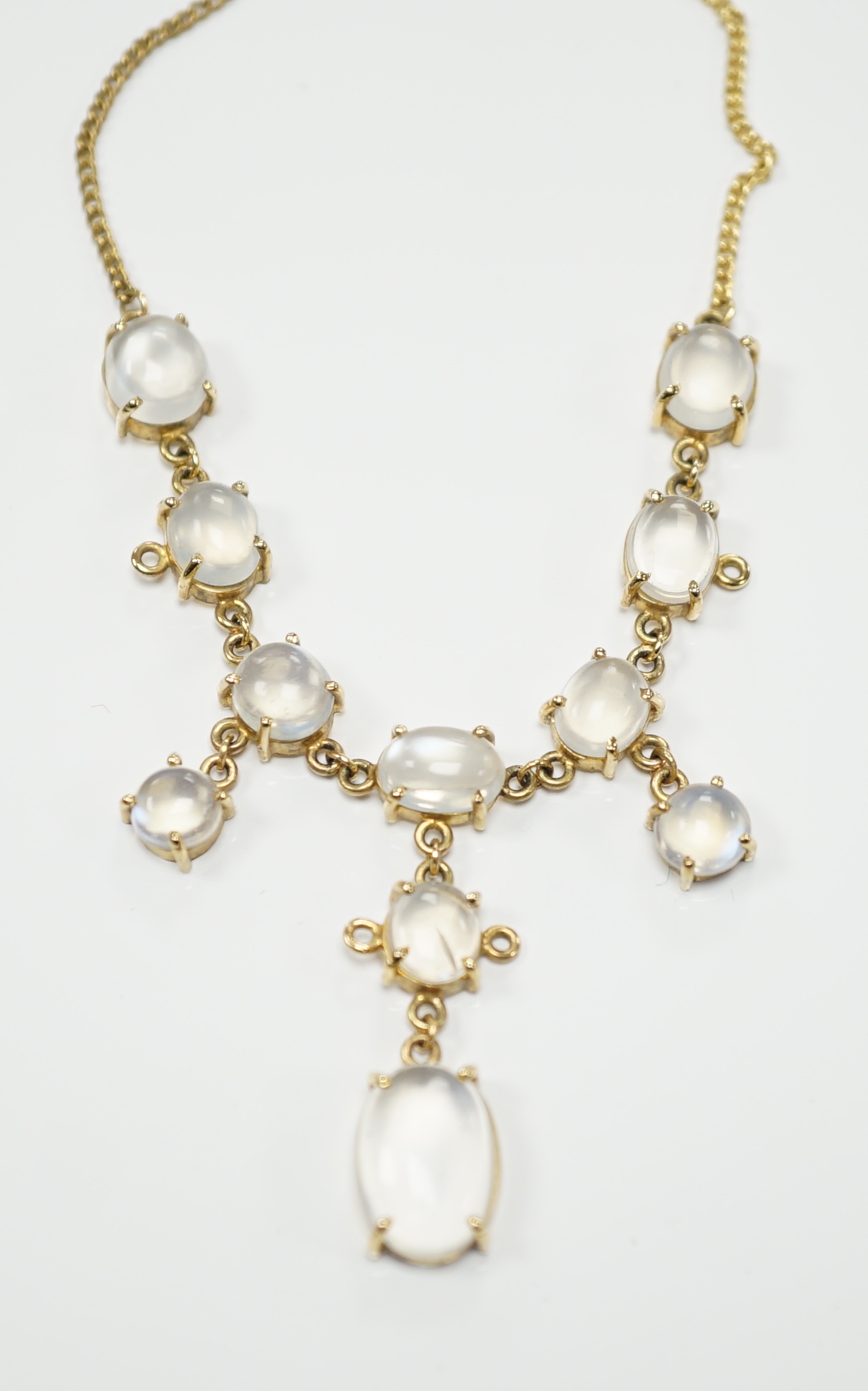 An Edwardian style 9k and cabochon moonstone cluster set drop necklace, 48cm, gross weight 11.2 grams.